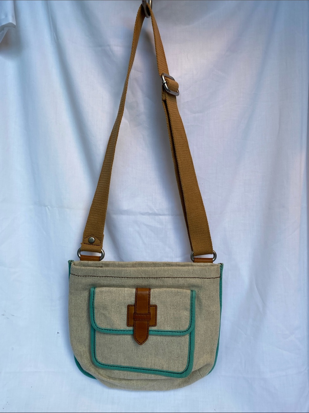 Fossil Canvas Crossbody Bag with Teal Trim and Brown Strap